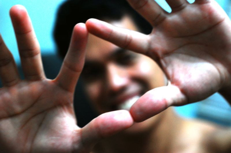 Un chico hace la forma del triángulo con las manos