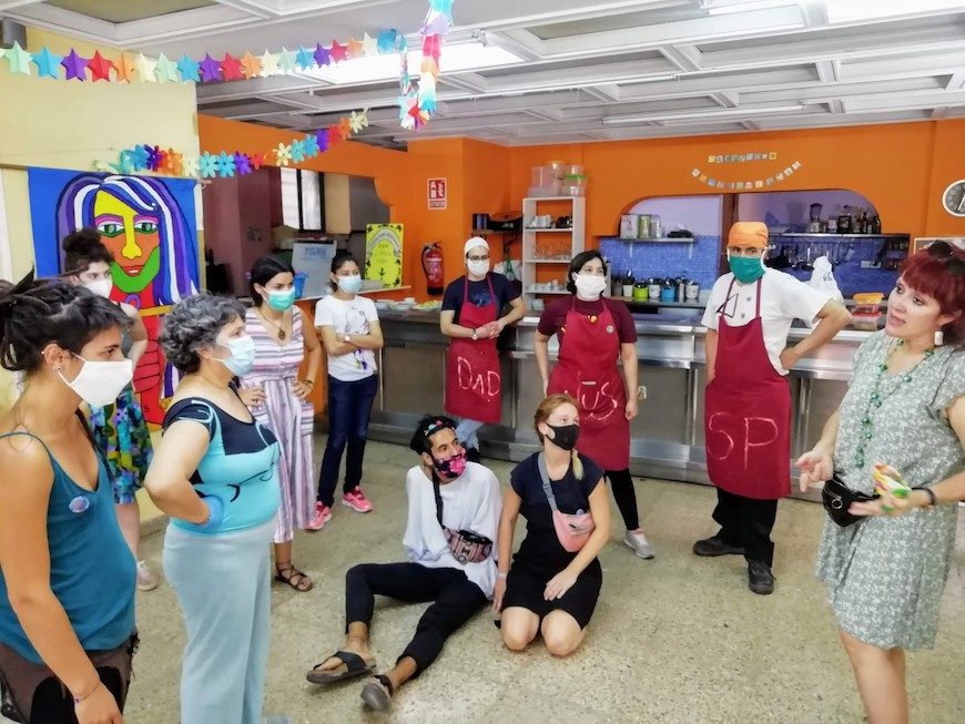 Voluntarias en el comedor de Pumarejo escuchan las indicaciones de una mujer. / Foto cedida por Mujeres Supervivientes para este reportaje sobre el colapso de los cuidados. 