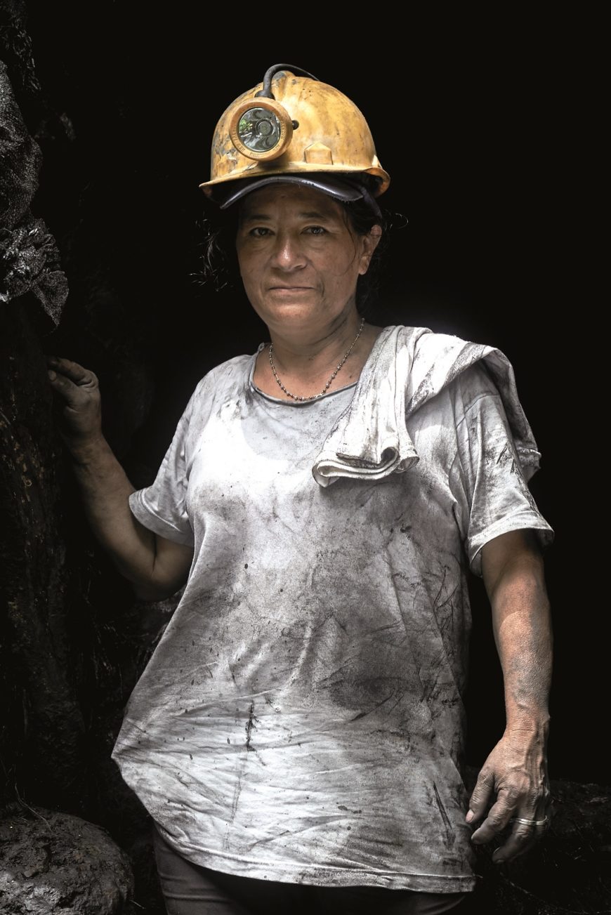 una mujer con casco de minera puesto